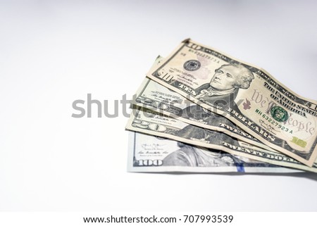 Dollars seamless background. High resolution seamless texture. Background from paper dollars of different advantage. Pile of United States dollar hundred USD banknotes on white table. Selective focus