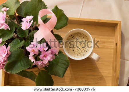 Breakfast for women - pink ribbon awareness symbol breast cancer. Coffee Cup on a wooden tray and pink violet. Royalty-Free Stock Photo #708003976