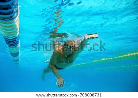 Swimmer in the big outdoor swimming pool Royalty-Free Stock Photo #708008731