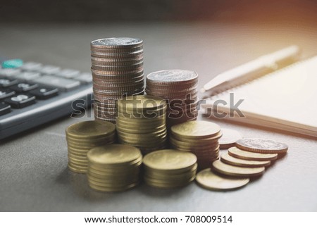 stack coin with black calculator and another coin. Financial and saving concept.