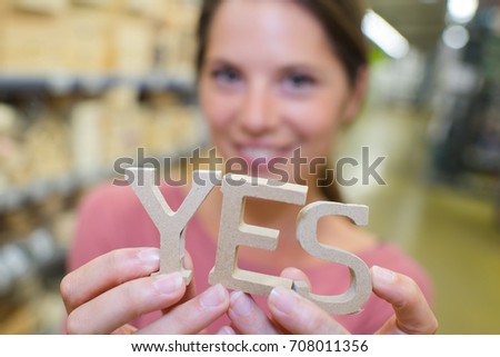 woman holding a yes word