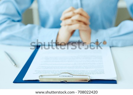 Hands of woman preparing to sign the contract document with pen on desk. selective focus image on sign a contract.