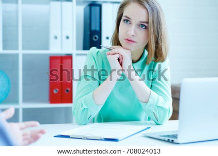 Young female employee of the staffing agency listening attentively the male job seeker. Business, office, law and legal concept.