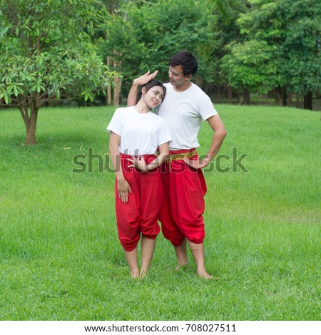 Asian young boy and girls learning Thai dance. Classical Dance in white shirt red loincloth, Demonstrate dance in the garden