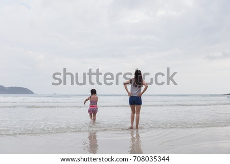 Girl take the baby to the beach on holiday.