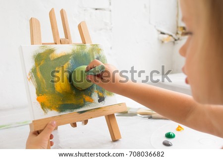 Little creative painter in working process. Early childhood education, artist workplace, interesting hobby for children, art concept