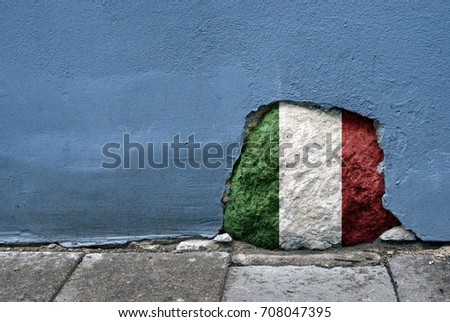 Concept image. Stone in the cement wall with Italy flag on it. National country's symbol. Traveling and patriotism theme.