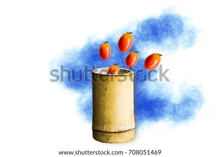 Bamboo cylinder with tomato on the wood background.Using wallpaper for package or product with concept, advertising and refreshing image.