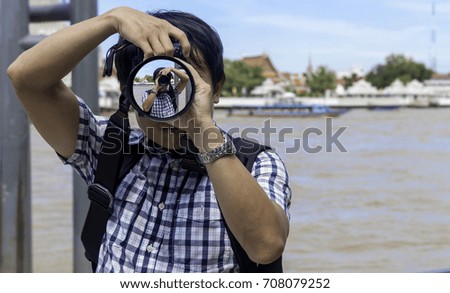 Tourist photography,The photojournalist has already reflected his lens.