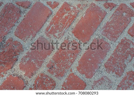 Angled Vintage Pale Red Brick Sidewalk with Beach Sand in Hawaii.