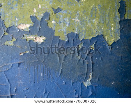 Old painted wall with cracks and peels. Abstract blue-green grunge cement wall texture and background. Multilayer paint of different colors.