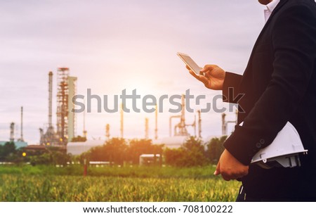 Engineer man talking telephone, Businessman working on construction building Oil refinery background