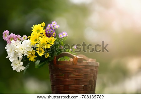 Beautiful fresh bouquet of flowers in a basket taken during early morning,ideal use as background.shallow dept of field
