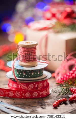 Christmas decoration with vintage ribbon spools for homemade gift boxes on christmas lighting bokeh background