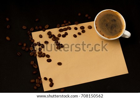 A cup of coffee and scattered coffee beans around the sheet is an empty space for the text