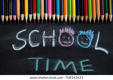 School time is written on a blackboard with colorful pencils