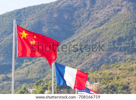 Flag, Chinese,French, American, Flag in a brisk breeze against a bright blue sky in summer background.