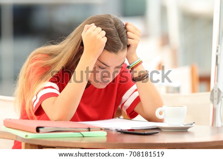 Single frustrated student girl trying to understand notes sitting in a bar Royalty-Free Stock Photo #708181519