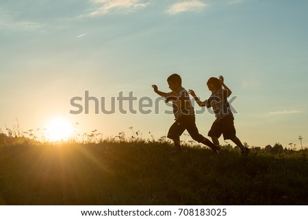 Silhoutte of two brothers enjoying the freedom
