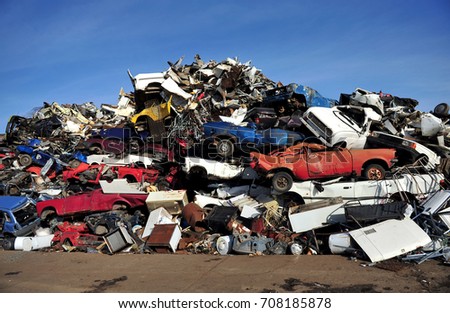 Old damaged cars on the junkyard waiting for recycling Royalty-Free Stock Photo #708185878