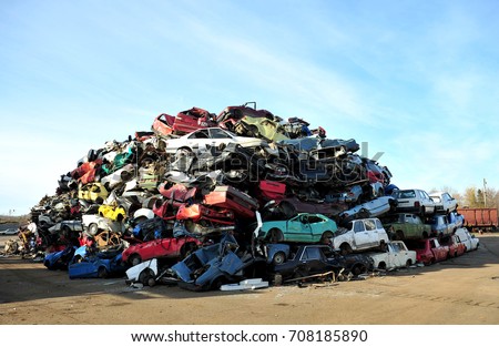 Old damaged cars on the junkyard waiting for recycling Royalty-Free Stock Photo #708185890