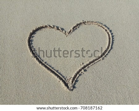 Heart icon on sand 