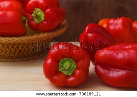 Fresh wet red paprika. Raw Red Organic Bell Peppers. Ripe bell peppers closeup. Picture with space for text or logos. Red peppers in basket