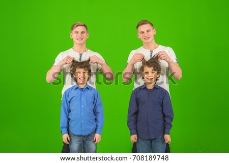 The four funny brothers stand on the green background