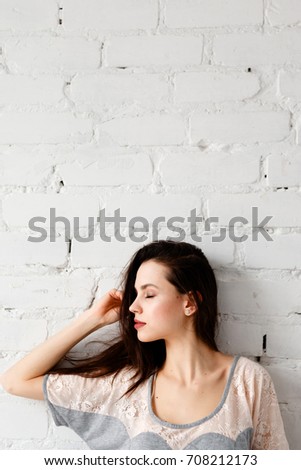 Young beautiful woman delights sunrise in the morning close up. Thoughtfulness, calmness and relaxation, dreams and memories concept. White background with free space