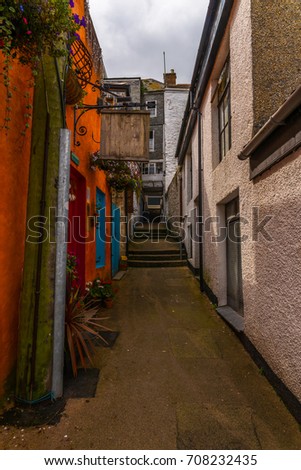 street in a seaside town, with colorful facades of buildings, english architecture, travel