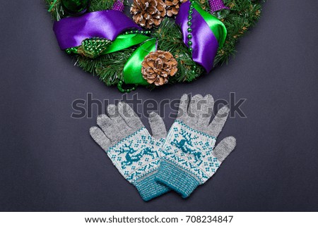 New year and christmas decoration with gloves on black background top view