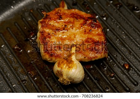 Meat, grilled steak in a frying pan
