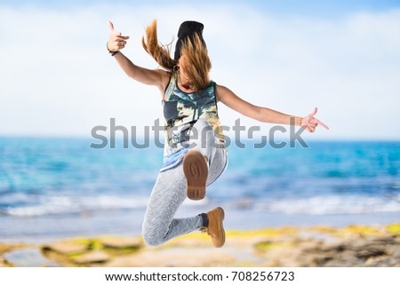 Woman dancing street dance on unfocused background