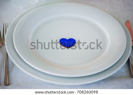 white ceramic plate with a blue heart