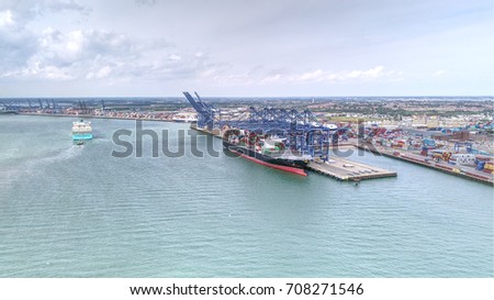 two large container ships, one arriving and one being loaded at Felixstowe port. Royalty-Free Stock Photo #708271546