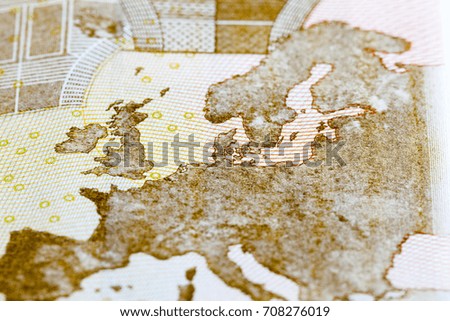 a Europe card on a fifty euro bill. close-up photo of the euro reverse