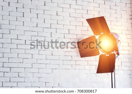 Light from the studio lights and white brick walls.