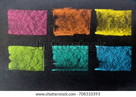 Multi color chalk drawing as striped line on black board background
