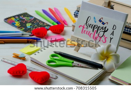 Happy teacher's day concept. Lovely greeting card for teachers writing in calligraphy handwriting style on white paper and wooden frame with students and school supplies on white wood desk background