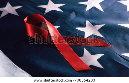 First of December, the day of the AIDS red ribbon on American flag background