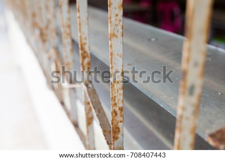 An old iron bars and louvers on window, close up.