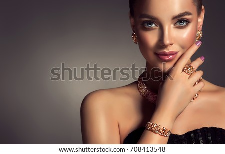 Beautiful girl with jewelry . A set of jewelry for woman ,necklace ,earrings and bracelet. Beauty and accessories.  bijouterie Royalty-Free Stock Photo #708413548