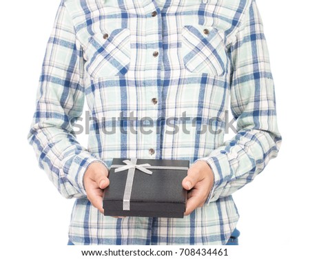 girl dressed in plaid shirt hold gift box in hands. Isolated on white background