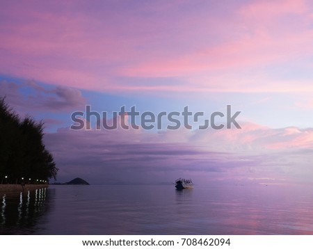 Beautiful twilight time and  broken boat in the sea. 
