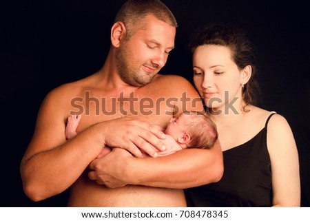 family dad and mather with newborn daughter