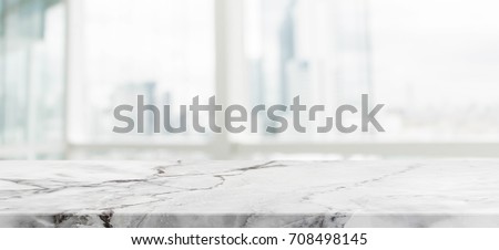 White marble stone table top and blur glass window wall building with city view background - can used for display or montage your products. Royalty-Free Stock Photo #708498145