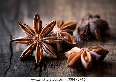 Anise stars closeup against dark rustic wooden background Royalty-Free Stock Photo #708498946