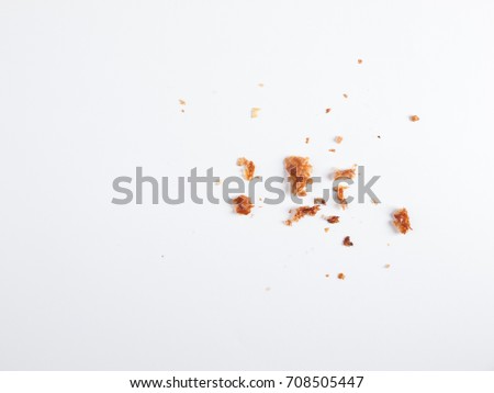 Scattered crumbs isolated on white background Royalty-Free Stock Photo #708505447
