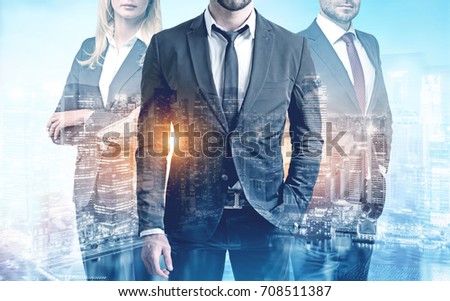 Close up of three members of a business team wearing suits and standing against a city view. Toned image double exposure