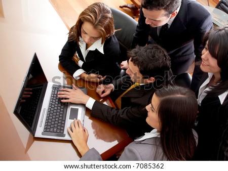 business team in an office laptop computer smiling